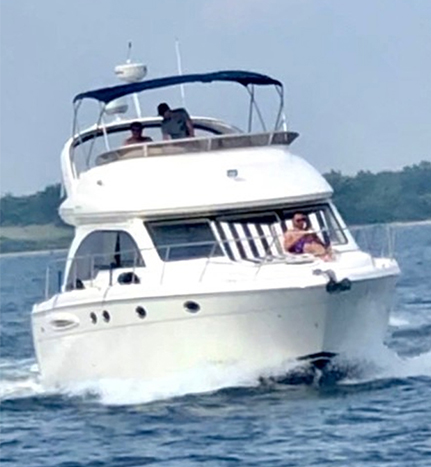 A boat with two people on it in the water.