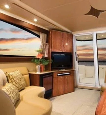 A living room with a couch, television and a table.